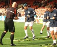 QPR players practice their rapid footwork during a warm-up.
